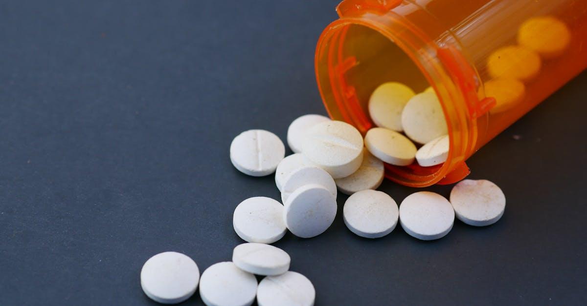 Pharmacist checking a controlled drug prescription behind the pharmacy counter