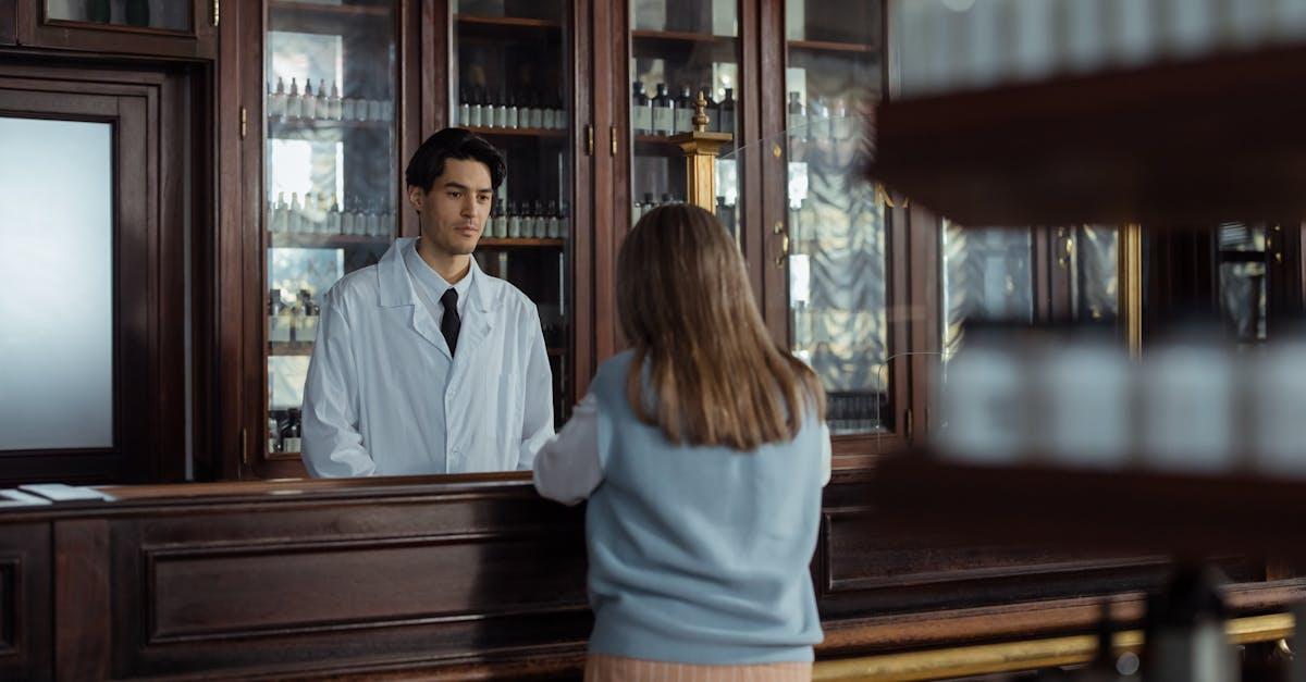 Pharmacist consulting with a patient in a modern pharmacy consultation room