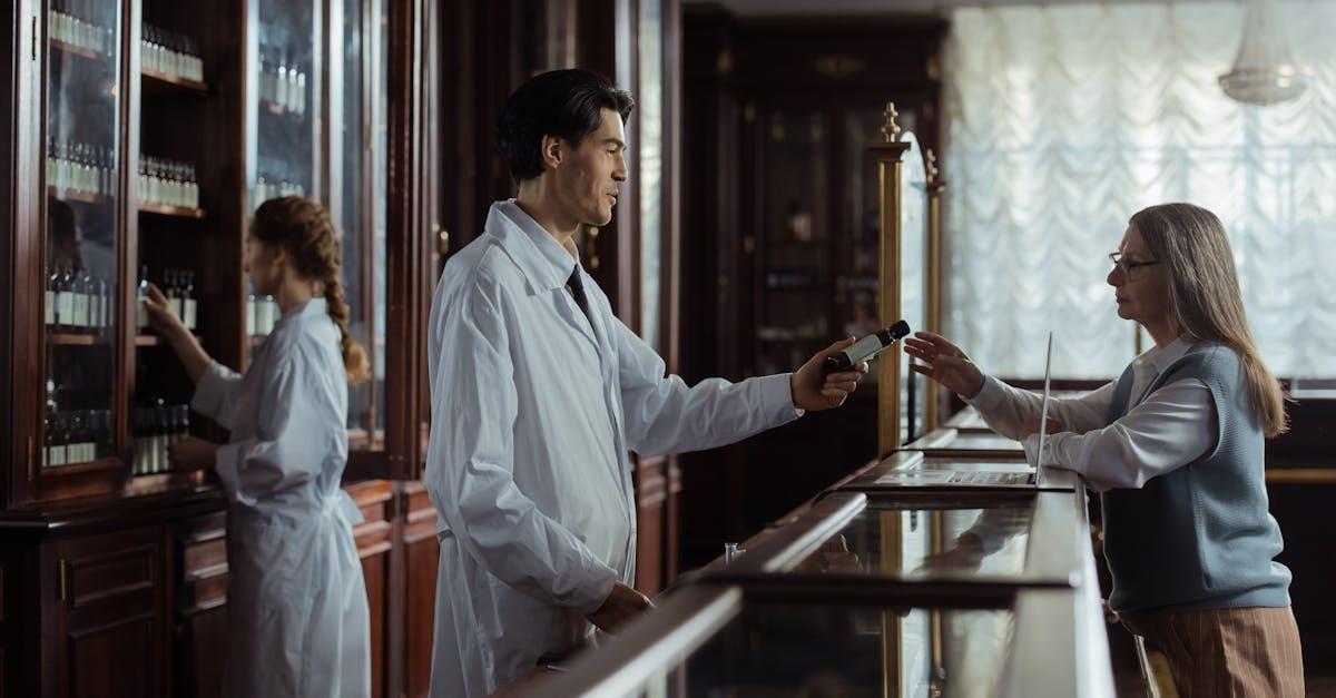 Pharmacist examining a skin condition during a consultation