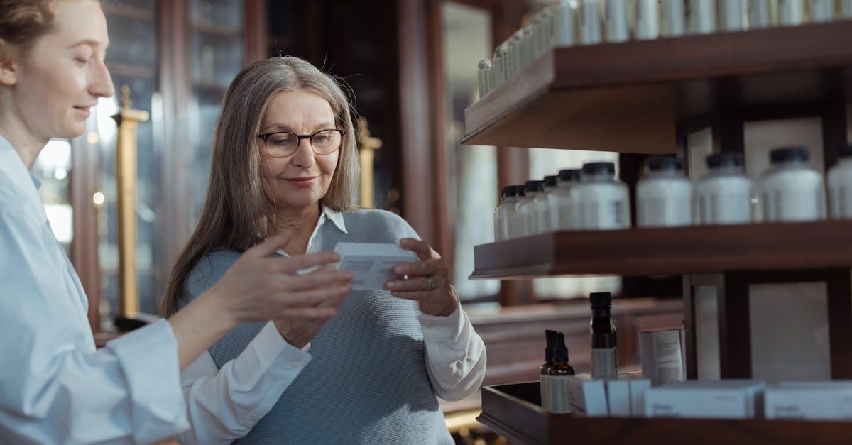 Pharmacist reviewing medications with a patient at the counter
