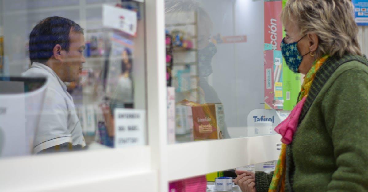 Pharmacist reviewing a patient's medication list before surgery