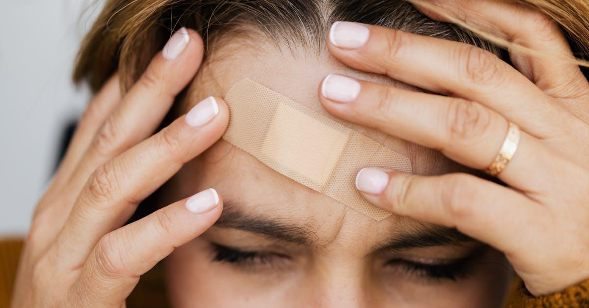 Person holding their forehead indicating sinus pain